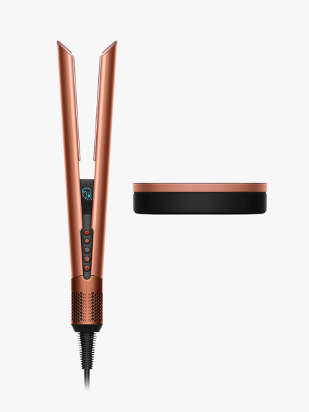Dyson Airstrait Straightener in Amber Silk and a case on a light gray background