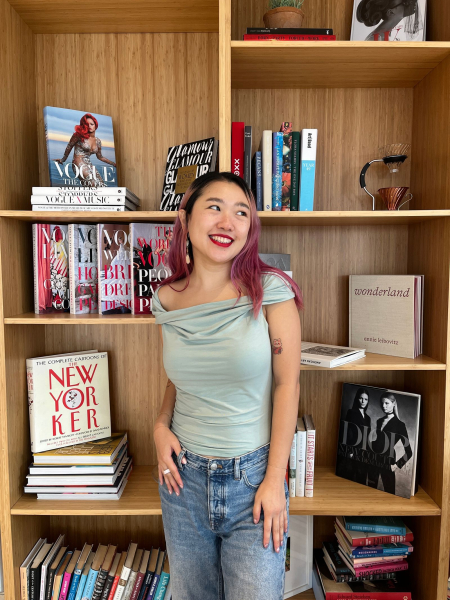 A photo of Allure commerce editor Sarah Han wearing a pair of Cakes Body Sticky Cakes Circles underneath a fitted green top